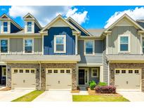 Charming townhome with stone accents, a two-car garage, and manicured lawn under a bright sky at 558 Dulaney Dr, Fort Mill, SC 29708
