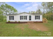 Charming single-story home with a well-manicured lawn and inviting front entrance at 450 Tot Dellinger Rd, Cherryville, NC 28021