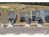 Aerial view showcases a well-maintained home with a landscaped yard within a vibrant neighborhood at 650 Scotch Meadows Loop, Monroe, NC 28110
