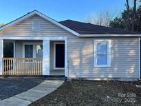 Charming single-story home featuring a covered porch and neutral siding at 2300 Olando St, Charlotte, NC 28206