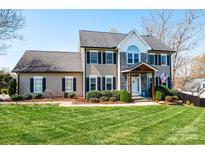 Charming two-story home with a well-manicured lawn, stone accents, and a covered front porch at 3765 11Th Ne St, Hickory, NC 28601
