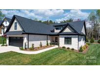 Charming single-story home featuring a well-manicured lawn, brick facade, and a paved walkway leading to the entrance at 4210 Holly Ne Cir, Conover, NC 28613