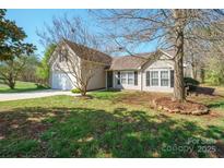 Charming single Gathering home with manicured lawn and attached two car garage at 5291 Moonlight Sw Trl, Concord, NC 28025