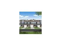 Charming townhome exterior featuring multiple garages, creating a delightful street view with manicured lawns at 6250 Tea Olive Dr # 240, Harrisburg, NC 28075