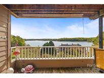 Relaxing balcony view overlooking a serene lake, perfect for enjoying the outdoors and nature at 9709 Emerald Point Dr # 6, Charlotte, NC 28278