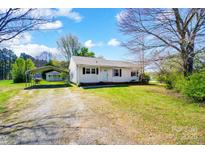 Charming single-story home with a quaint covered parking area surrounded by a well-maintained lawn at 130 Atwell Rd, Mt Ulla, NC 28125