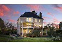 A beautiful brick home showcasing a large backyard, dual decks, and outdoor living spaces, perfect for entertaining at 13833 Jonathans Ridge Rd, Mint Hill, NC 28227