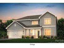 Charming two-story home with gray siding, a two-car garage, and professionally landscaped front yard at 1385 Coppergate Dr, Salisbury, NC 28147