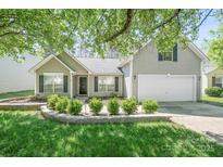 Charming single-Gathering home showcasing a well-manicured front yard and attached two-car garage at 1838 Summit Ridge Ln, Kannapolis, NC 28083