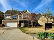 Charming two-story home featuring a brick and siding exterior, manicured lawn, and an attached two-car garage at 2741 Smethwick Ln, Gastonia, NC 28056