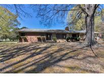 Charming brick home with mature trees and well-maintained landscaping creates inviting curb appeal at 3609 Southwood Dr, Gastonia, NC 28056