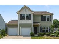 Charming two-story home featuring a two-car garage, neutral siding, and well-maintained landscaping at 4213 Stockbrook Dr, Charlotte, NC 28215
