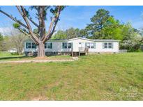 Charming single-story home with green shutters and mature trees on a spacious lawn at 574 Pamela Rd, York, SC 29745