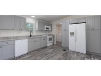 Modern kitchen featuring gray cabinets, stainless steel appliances, and granite countertops at 574 Pamela Rd, York, SC 29745