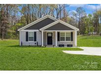 Charming single-story home with a well-manicured lawn and a classic exterior design at 5962 Charlie Walker Rd, Kannapolis, NC 28081