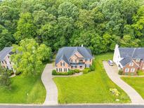 Aerial view of a beautiful brick home with a large front yard and mature trees, showcasing its desirable neighborhood setting at 1102 High Brook Dr, Waxhaw, NC 28173