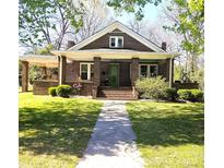 Charming brick home with a covered front porch and well-maintained lawn at 146 Saluda St, Chester, SC 29706