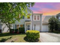 Charming two-story home with a well-manicured lawn and attached two-car garage at 15619 Lakepoint Forest Dr, Charlotte, NC 28278