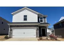 Charming two-story home featuring stone accents, white siding, and a spacious two-car garage at 159 Shepherds Landing Dr, Mooresville, NC 28115