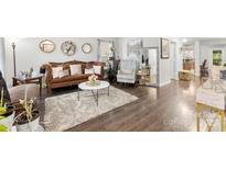Cozy living room showcasing hardwood floors, elegant furnishings, and a well-lit, inviting atmosphere at 2011 Dunsmore Ln # 137, Waxhaw, NC 28173
