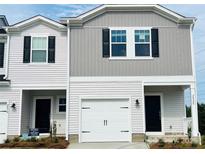 Charming townhome featuring neutral siding, a one-car garage, and a welcoming front entrance at 2020 Old Rivers Rd, Concord, NC 28027
