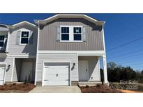 Charming two-story townhome features a one-car garage and welcoming front entrance at 2020 Old Rivers Rd, Concord, NC 28027