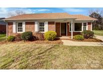 Charming brick home with a manicured lawn and bright white shutters, offering classic curb appeal at 2224 Thornfield Rd, Charlotte, NC 28217