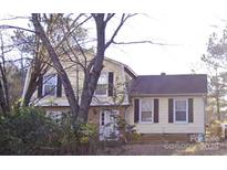 Charming two-story home with a traditional design and a well-maintained front yard partially obscured by trees at 2508 Wood Star Ct, Matthews, NC 28105
