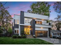 Modern two-story home with striking architectural details and a yellow front door at 2529 Daniel St, Charlotte, NC 28205