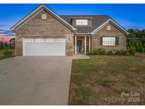 Charming single-story brick home with a two-car garage and inviting front yard at 3810 New Salem Rd, Monroe, NC 28110