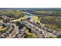 Beautiful aerial view of homes near golf course and a river surrounded by lush green trees and blue sky at 39617 Rosebay Ct, Fort Mill, SC 29707