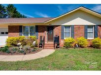 Charming brick home featuring a manicured lawn and walkway leading to the front door at 841 E Zion Church Rd, Shelby, NC 28150