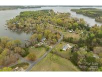 An aerial view shows a desirable lakeside neighborhood with mature trees and private docks along the water at 130 Golfers Dr # 1, Salisbury, NC 28146