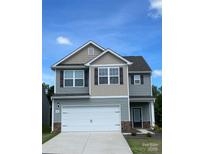 Charming two-story home with gray and beige siding, complemented by a two-car garage and neatly landscaped front yard at 1564 Doran Ter, Richburg, SC 29729