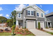 Charming townhome features a two-car garage and inviting curb appeal with landscaped front yard at 2365 Hedgecliff Rd, Kannapolis, NC 28025