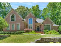 Stunning brick home with well-manicured lawn and mature trees offers timeless elegance and curb appeal at 310 Berkeley Rd, Rock Hill, SC 29732