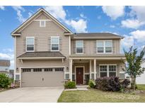 Charming two-story home featuring a two-car garage, covered entry, and well-maintained landscaping at 4630 Bent Green Ln, Monroe, NC 28112