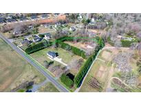 A captivating aerial view of a property with well-maintained landscaping and a long driveway in a suburban neighborhood at 4875 Sulpher Springs Ne Rd, Hickory, NC 28601