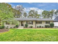 Charming brick home with a well-manicured lawn and lush landscaping at 500 Lansdowne Rd, Charlotte, NC 28270