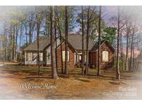 Charming single-story brick home featuring a well-maintained lawn and mature trees at 620 St Lukes Church Rd, Salisbury, NC 28146