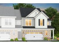 Charming two-story home showcasing brick accents, contrasting siding and two-car garage at 2231 Cobble Ct # 218, Monroe, NC 28110