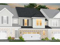 Charming townhome featuring a one-car garage, grey siding, and a beautifully landscaped front yard at 2233 Cobble Ct # 219, Monroe, NC 28110