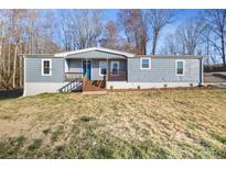 Charming single-story home featuring a welcoming front porch and a well-maintained yard at 2390 Old Wilkesboro Rd, Statesville, NC 28625