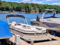 A pontoon boat on a private dock shows waterfront living at its finest at 4599 Rustling Woods Dr, Denver, NC 28037