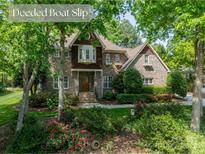 Charming two-story brick home with mature landscaping and inviting front entrance at 4599 Rustling Woods Dr, Denver, NC 28037
