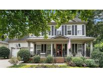Charming home featuring a lovely front porch, manicured landscaping, and classic black shutters at 7215 Meyer Rd, Fort Mill, SC 29715
