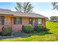 Charming single-story brick home with a well-maintained lawn and traditional landscaping at 970 Willowbrook Ave, Rock Hill, SC 29730