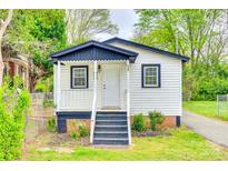 Charming cottage-style home with white siding, black trim, and inviting front porch at 110 Steele St # 34 35, Fort Mill, SC 29715