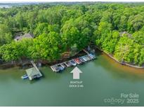 Scenic aerial view showcasing the boat slip and lush greenery surrounding the Lake Norman property at 4646 Eagle Pointe Ct, Denver, NC 28037