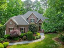 Beautiful brick home featuring manicured landscaping and a welcoming front entrance at 4646 Eagle Pointe Ct, Denver, NC 28037